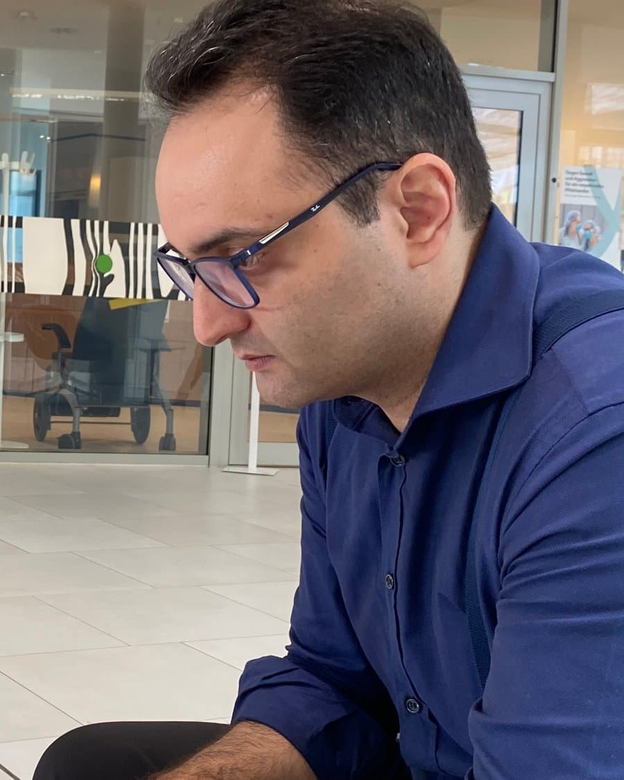 Reza Motaghi, oral and maxillofacial radiologist, at work in a hospital atrium